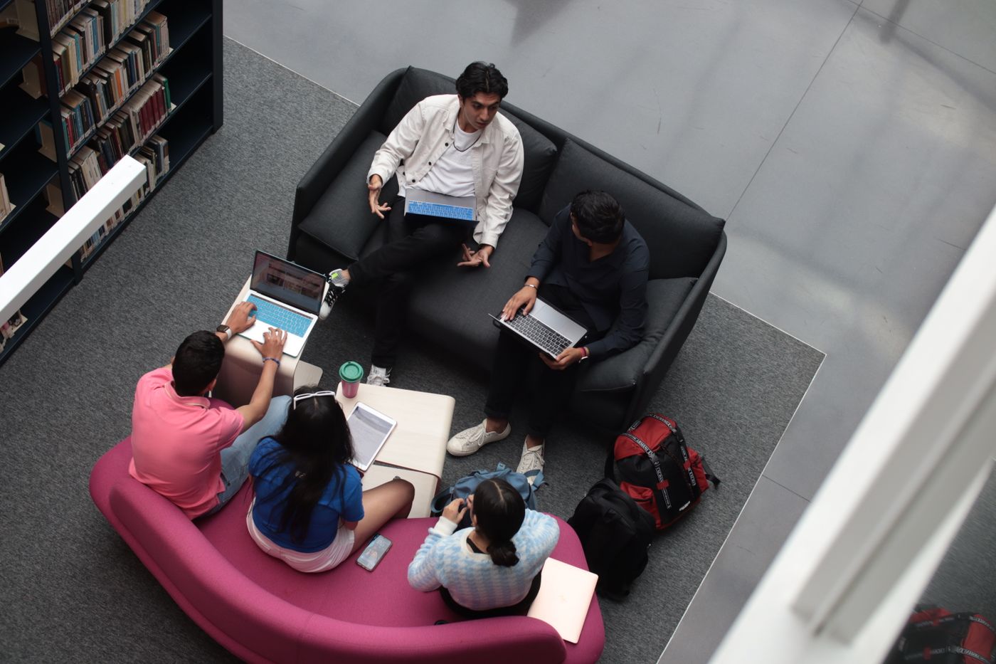 Students sharing ideas around a library table